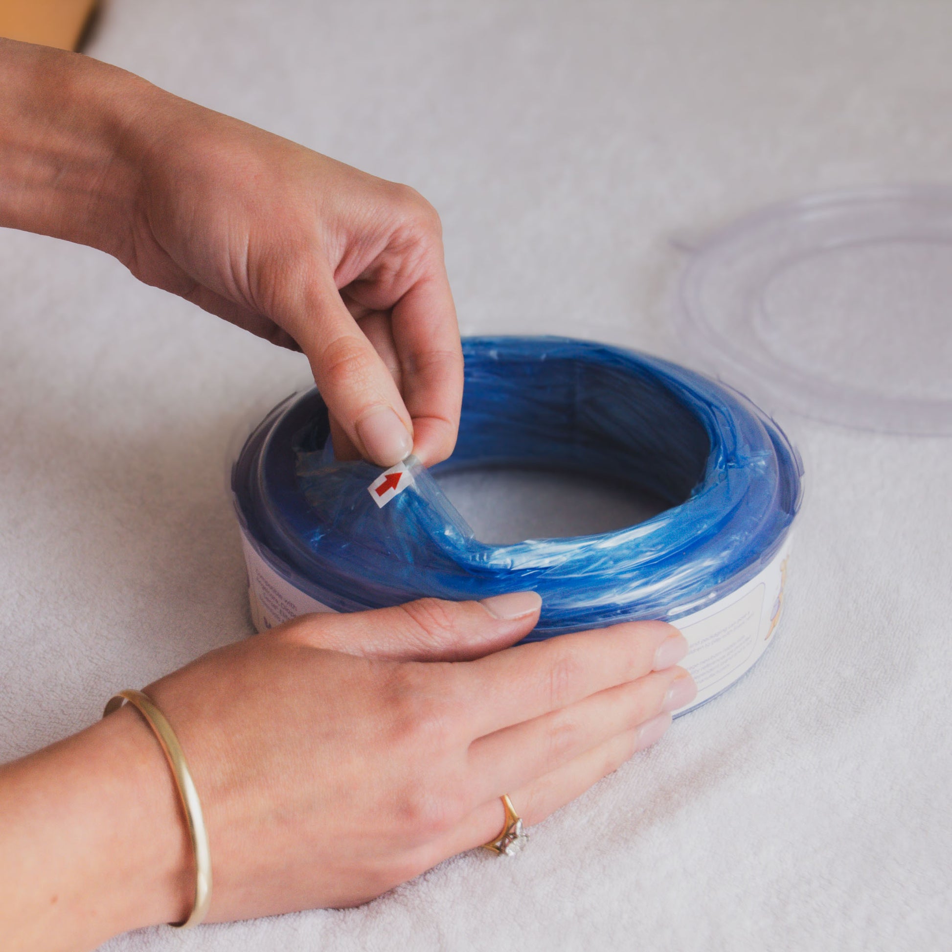 Bagaroo refill cassette being loaded into an Angelcare nappy disposal bin