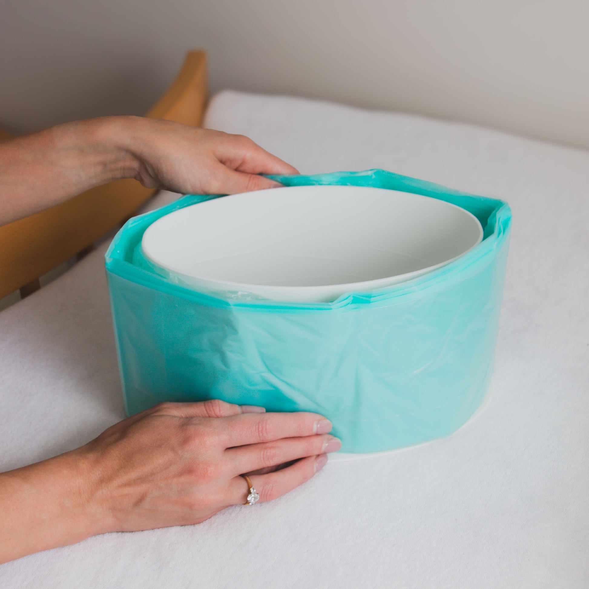 Bagaroo refill roll being loaded into a Korbell 16L nappy disposal bin